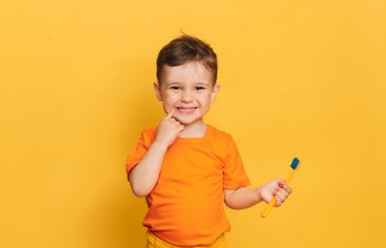 cheerful little boy with a toothbrush