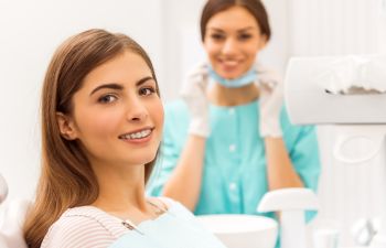 Woman Smiling While in Dentist Chair